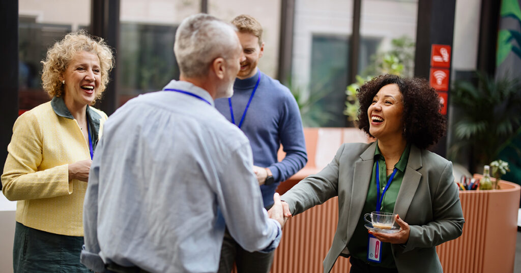 image of people shaking hands and sharing information: networking!